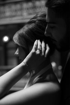 black and white photograph of a man and woman holding each other's hands together