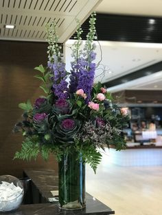 a vase filled with purple flowers on top of a table