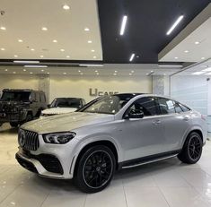 the new mercedes gle - class is displayed in a showroom