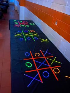 neon tic - tac - toe game on the floor in an indoor room