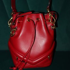 Crafted From Genuine Calfskin Leather In A Vibrant Red Hue, This Fendi Mini Mon Tresor Bucket Bag Is Both Chic And Trendy. The Sleek Design Features A Leather Hand Strap, A Matching Cross Body Strap, And Luxurious Gold Hardware. The Suede Interior Reveals Ample Space For All Your Daily Essentials. With A Base Length Of 4.50 In, Height Of 6.75 In, And Adjustable Drop Straps At 4.25 In And 21.25 In, This Bag Is Perfect For Any Occasion. Fendi Mini, Hand Strap, Daily Essentials, Fendi Bags, Leather Mini, Vibrant Red, Gold Hardware, Red Leather, Sleek Design