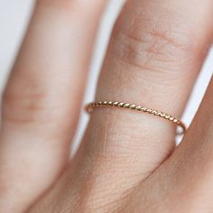 The Barely There Twist is a sweet, delicate, twisted band for the one who is all about texture. This ring is the loveliest solid gold rope you ever did see, and will effortlessly add a textured contrast to your ring stack. The Barely There Twist is also great for rocking the minimalistic look and can be worn by itself. Style it either way, but this classic beauty is a must have for your jewelry collection! Minimalist Rings Stacking, Rings Stacking, Solid Gold Band, Engagement Ring Guide, Ring Stack, Twisted Band, Mens Band, Minimalist Rings, Custom Engagement Ring