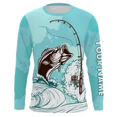 a long sleeved shirt with a fish on it and fishing rod in the water