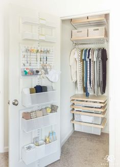 an organized closet with white shelving and hanging items