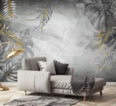 a living room with a couch, rug and wallpaper that has gold leaves on it