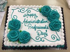 there is a cake with blue roses on it that says happy annivering professionals day