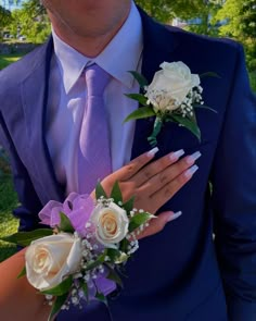 a man in a suit and tie with flowers on his lapel flower bouquets