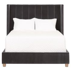 an image of a bed with white sheets and pillows on it's headboard