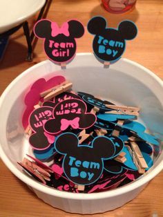 mickey mouse cupcake toppers with team boy and girl on them in a bowl