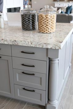 a kitchen island with two jars on it