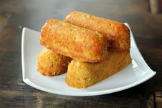 three pieces of fried food on a white plate