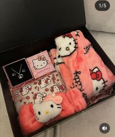 the hello kitty gift box is packed with pink and white blankets, plush toys, and jewelry