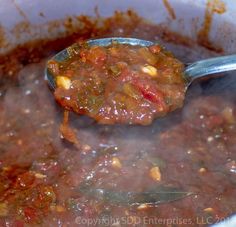 a spoon full of soup is being stirred