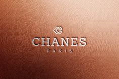 the logo for chanes paris is shown on a brown leather surface with silver lettering