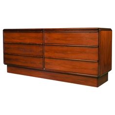 a large wooden dresser sitting on top of a white wall