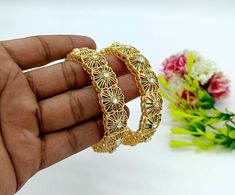 Features:- * An Indian styled Meenakari Flower Bangles. * Made from fine Quality Brass with Matte Gold Platting. * Ready to be given as a gift. * Easy and Convenient way to Wear. * It looks prettier than the images. Direct Images on hand is also attached. Size of Bangles & Other Details:- Matte Gold Plated Meenakari Flower Bangles Choose your size from the drop down box SIZES AVAILABLE 2.4, 2.6 & 2.8 - 2.4 diameter 2.25" - 2.6 diameter 2.37" - 2.8 diameter 2.5" Material - Matte Gold Plated Brass Quantity - One Pair This gold plated unique bangles is glamorously impressive, yet subtle, the design is clean and extremely accurate and suited to any kind of event, both formal and informal, featuring an amazing stones, this is one of my favorite items!  It looks beautiful, is durable & also affo Festive Multicolor Bracelets With Latkans, Multicolor Diwali Bracelets With Motifs, Multicolor Motif Bracelets For Diwali, Multicolor Diwali Motif Bracelets, Diwali Multicolor Motif Bracelets, Diwali-themed Multicolor Bracelet With Motifs, Bohemian Bracelets With Latkans For Diwali, Bohemian Bracelets With Motifs For Diwali, Adjustable Multicolor Cutdana Bracelets