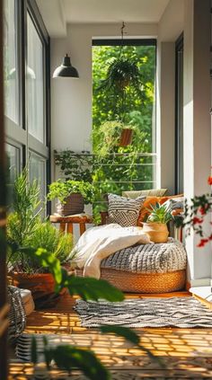 a porch with plants and wicker furniture on the floor, along with large windows