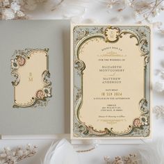 the wedding card is on display next to some flowers