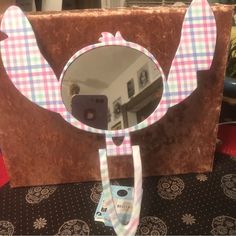 a mirror that is shaped like an elephant with a bow tie on it's head