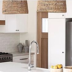 a kitchen with white cabinets and an island in front of a stove top oven next to a sink