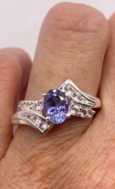 Rich and very bright blue iolite ring set with white sapphire accents.  925 Sterling silver  Size can be sized by my jeweler. His service charge is $20 All rings are shipped in a nice gift box.   Check out our over a THOUSAND great reviews Engraving is $4 per letter and is not always perfect depending on the piece. It can take a few days if the jeweler is busy. This is payable to Paypal Judithsltd@gmail.com Dazzling Tanzanite Rings For Gift, Tanzanite Rings With Diamond Accents For Promise, Tanzanite Diamond Ring As A Gift, Dazzling Tanzanite Promise Rings, Silver Tanzanite Diamond Ring With Accent Stones, Silver Tanzanite Promise Ring, Blue Amethyst Ring For Anniversary In Fine Jewelry Style, Silver Tanzanite Birthstone Ring With Accent Stones, Blue Amethyst Ring For Anniversary