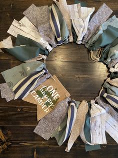 a wreath made out of old cloths on a wooden table with the words coffee break