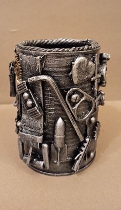 a metal cuff with various tools on it