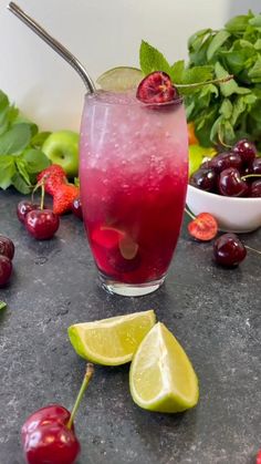 someone pouring water into a glass with fruit around it