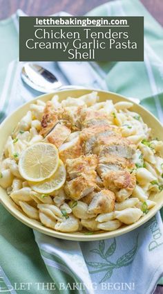 chicken tenders creamy garlic pasta is served in a bowl with lemon wedges on the side