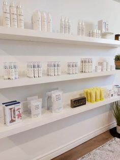 the shelves are filled with different types of personal care products on display in front of a white wall