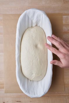 a person is pressing the dough into a ball