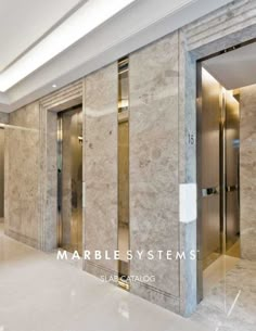 an elevator with marble walls and doors