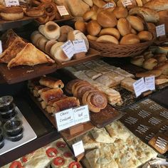 breads and pastries are on display in a bakery