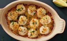 a casserole dish with scallops and parmesan cheese