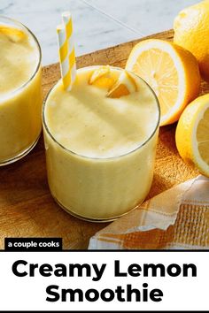 two glasses filled with creamy lemon smoothie on top of a cutting board