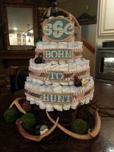 a cake made out of diapers with the words born to hunt on it