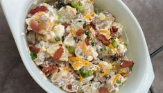 a white bowl filled with potato salad on top of a table