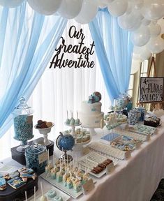 the dessert table is decorated with blue and white balloons