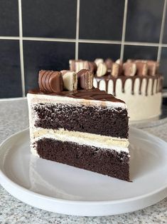 a piece of cake on a plate with chocolate and white frosting in the middle