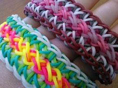 three different colored bracelets sitting on top of each other's hands, with one being held in the other hand