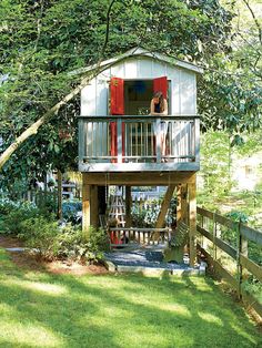 a woman standing on the balcony of a small house