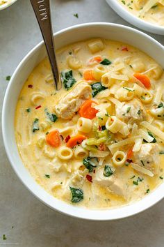 two bowls filled with pasta and chicken soup