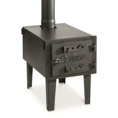 a black stove sitting on top of a wooden table next to a metal pole with the words club gear written on it