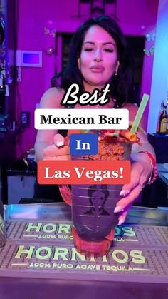 a woman holding a drink in her hand with the caption best mexican bar in las vegas