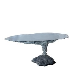 a table that has some kind of rock on it with water coming out of it