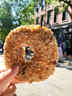 a person holding up a donut that has been made out of oatmeal