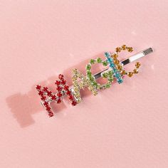 Honey, you're magical! So let everyone know with our Rainbow Magic Hair Pin. With a silver hair pin-style base, this gem features rhinestone lettering in red, yellow, green, blue, and orange - making for a kaleidoscope of magic✨ Care + Content: Rhinestones Metal Dimensions: 1" tall letters Tall Letters, Silver Hair Pin, Rainbow Magic, Rhinestone Letters, Wooden Rainbow, Magic Hair, Rainbow Earrings, Wine Stoppers, Blue And Orange