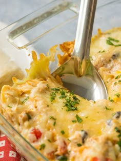 a glass casserole dish filled with cheese and vegetables