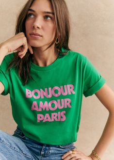 Short-sleeved organic cotton T-shirt;\"Bonjour Amour Paris\" print on front;Crew neck;Length from the shoulder: 60 cm / 23.6 in (for a S) Cotton Tshirt Women, All Over Print Tshirt Women, Love More Shirts, Love Print T Shirt, Tshirt Tops For Women, Paris Women Shirt, French Graphic Tee, Travel T Shirt, Outfits With Green Shirt