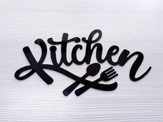 the word kitchen is made out of black metal